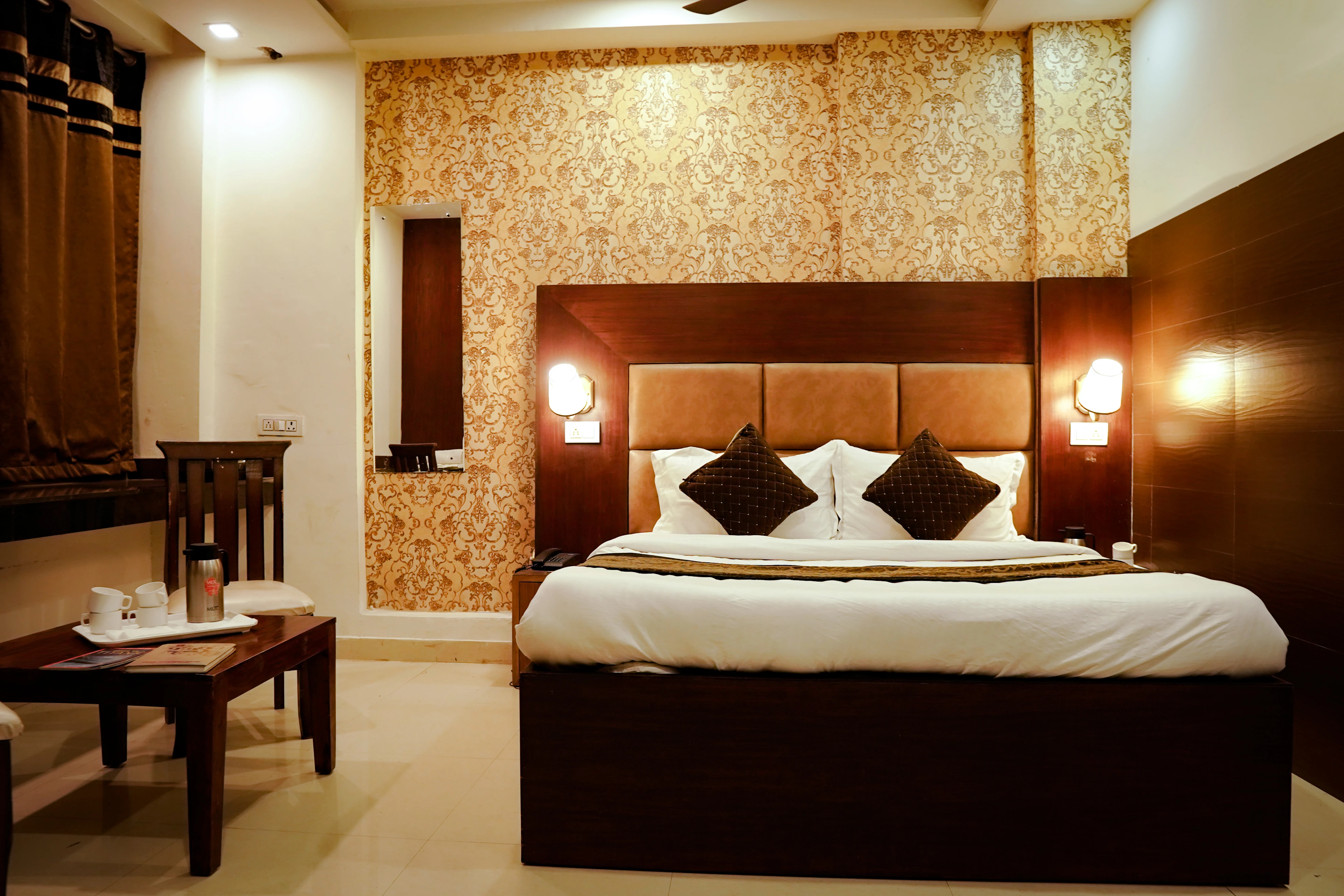 Deluxe Room seating with coffee table and two chairs